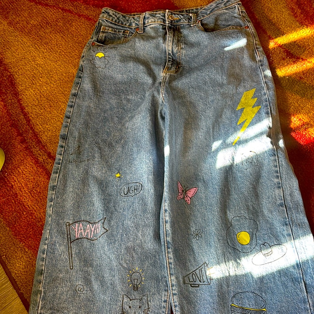 Blue bell bottom jeans with different designs
